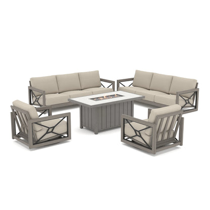 Isolated product shot of the grand Marindo patio deep seating collection against a white background, showcasing active amber flames on the propane fire pit surrounded by two sofas and two swivel chairs.