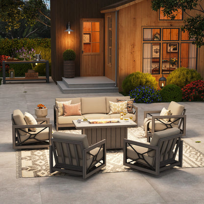 Upscale backyard gathering setting at twilight featuring the Marindo 7-person patio conversation set, with cozy amber flames from the fire pit table illuminating four swivel club chairs and a matching sofa.