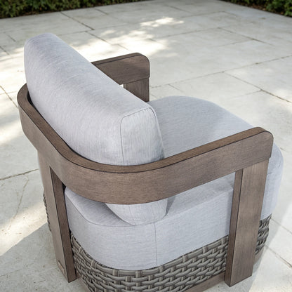 High-angle top view highlighting the architectural curved backrest and light gray fabric cushion of the Manarola patio lounge chair.