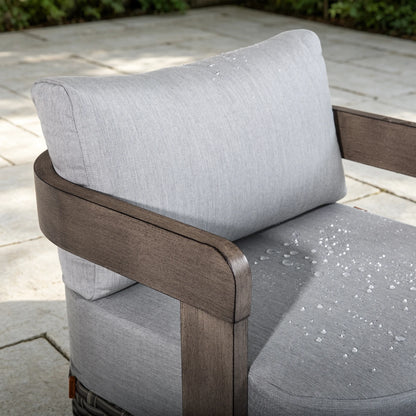 Close-up of water droplets beading up on the weather-resistant Sunbrella fabric cushion of a Manarola fixed club chair.