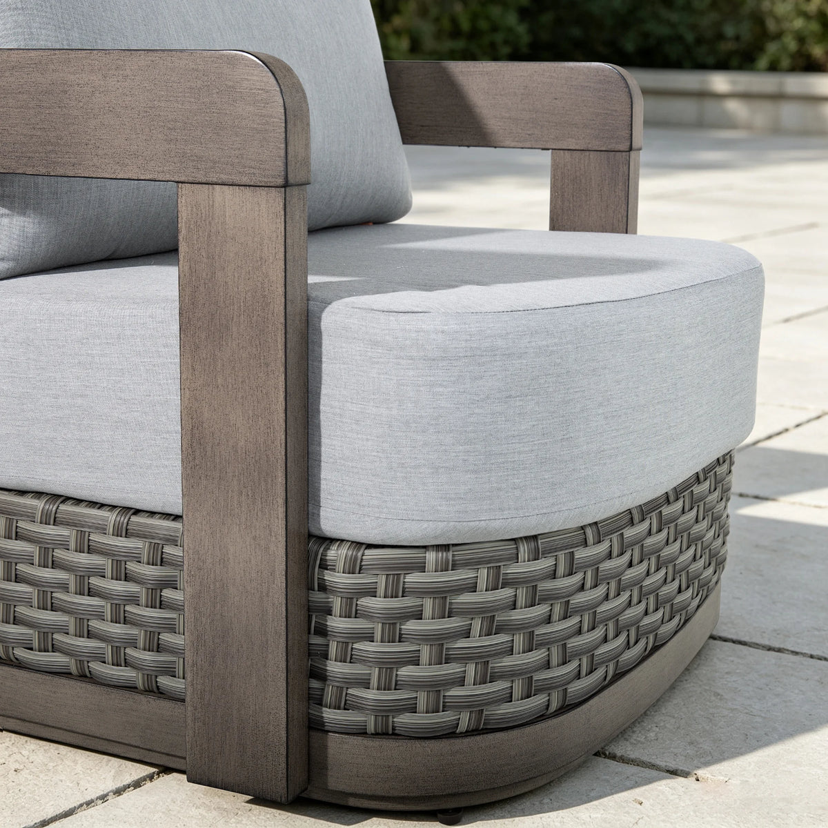 Detailed close-up showing the non-swivel architectural aluminum frame and premium hand-woven gray PE wicker base of the Manarola club chair.
