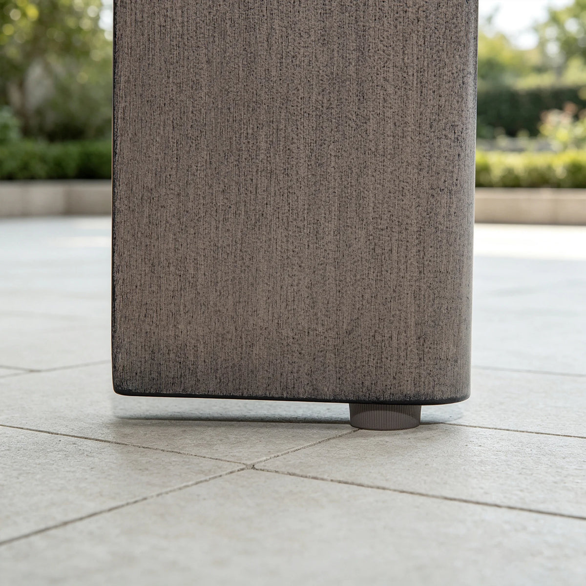 Close-up of the non-slip adjustable leveling foot mat underneath the leg of the Manarola aluminum outdoor table.