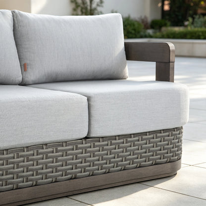Close-up perspective of the ultra-plush 6.5-inch thick gray Sunbrella seat and back cushions styled on a sunny backyard deck.