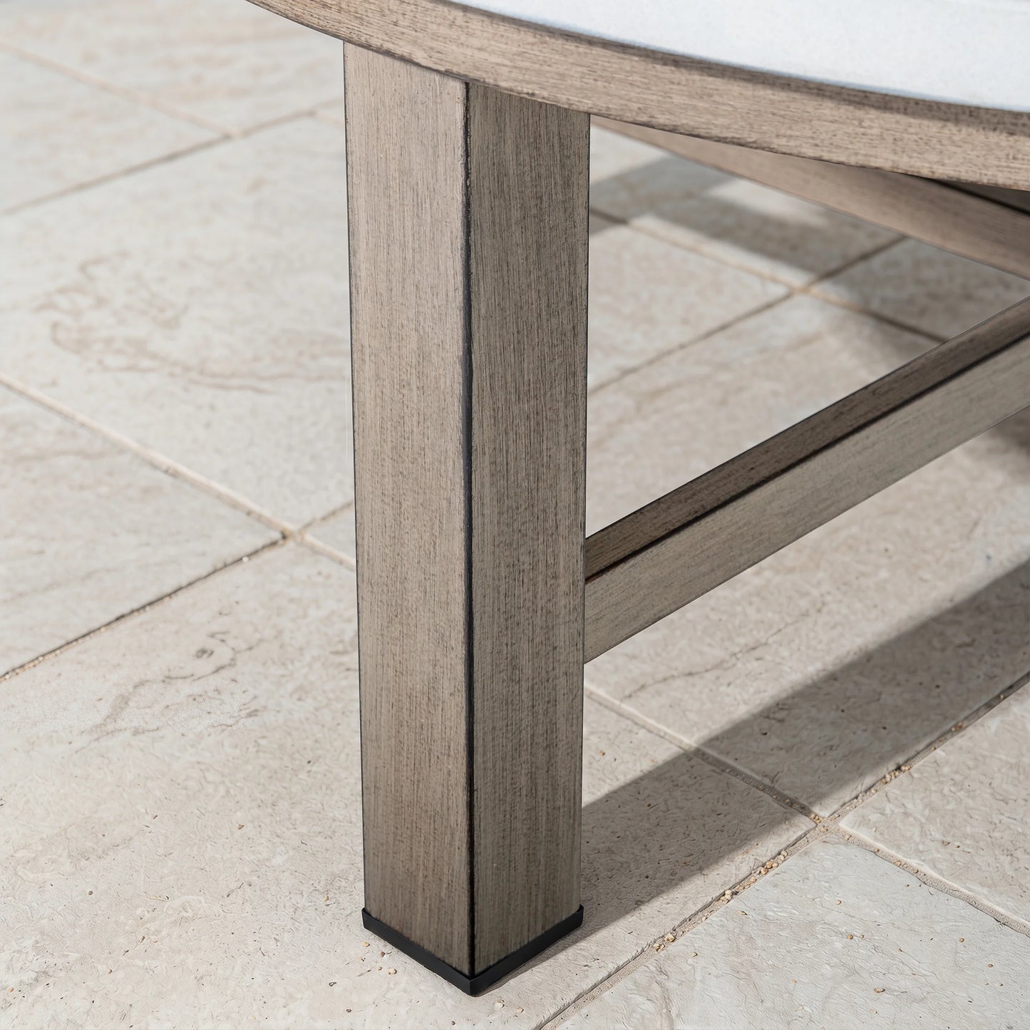 Close-up of a wood-look table leg on a tiled floor