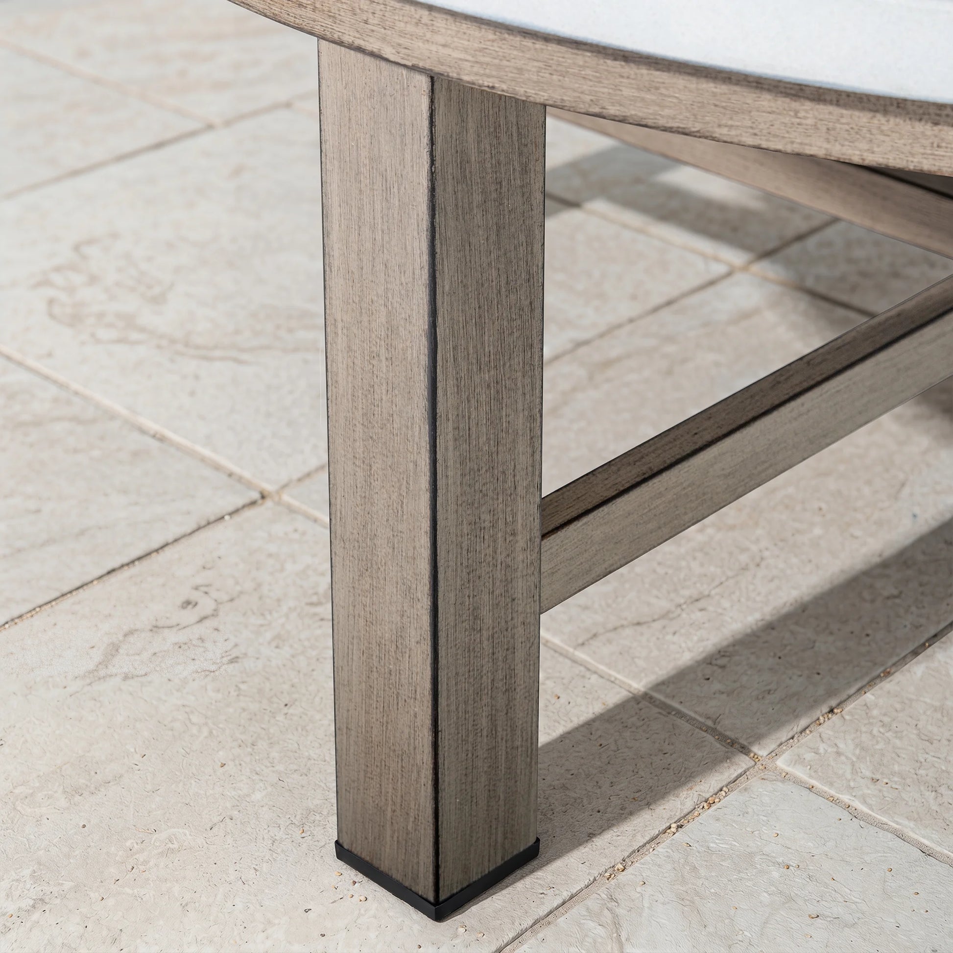 Close-up of a wood-look table leg on a tiled floor