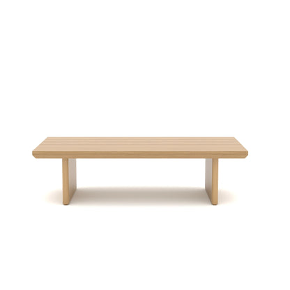 Clean straight-on front view of a minimalist rectangular patio table with a light oak wood grain finish and solid geometric base.