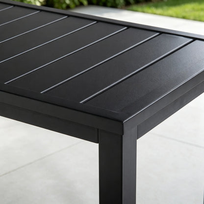 Detail shot of the top corner joint of Saporta table, highlighting the sleek matte black finish and sturdy slatted metal construction.