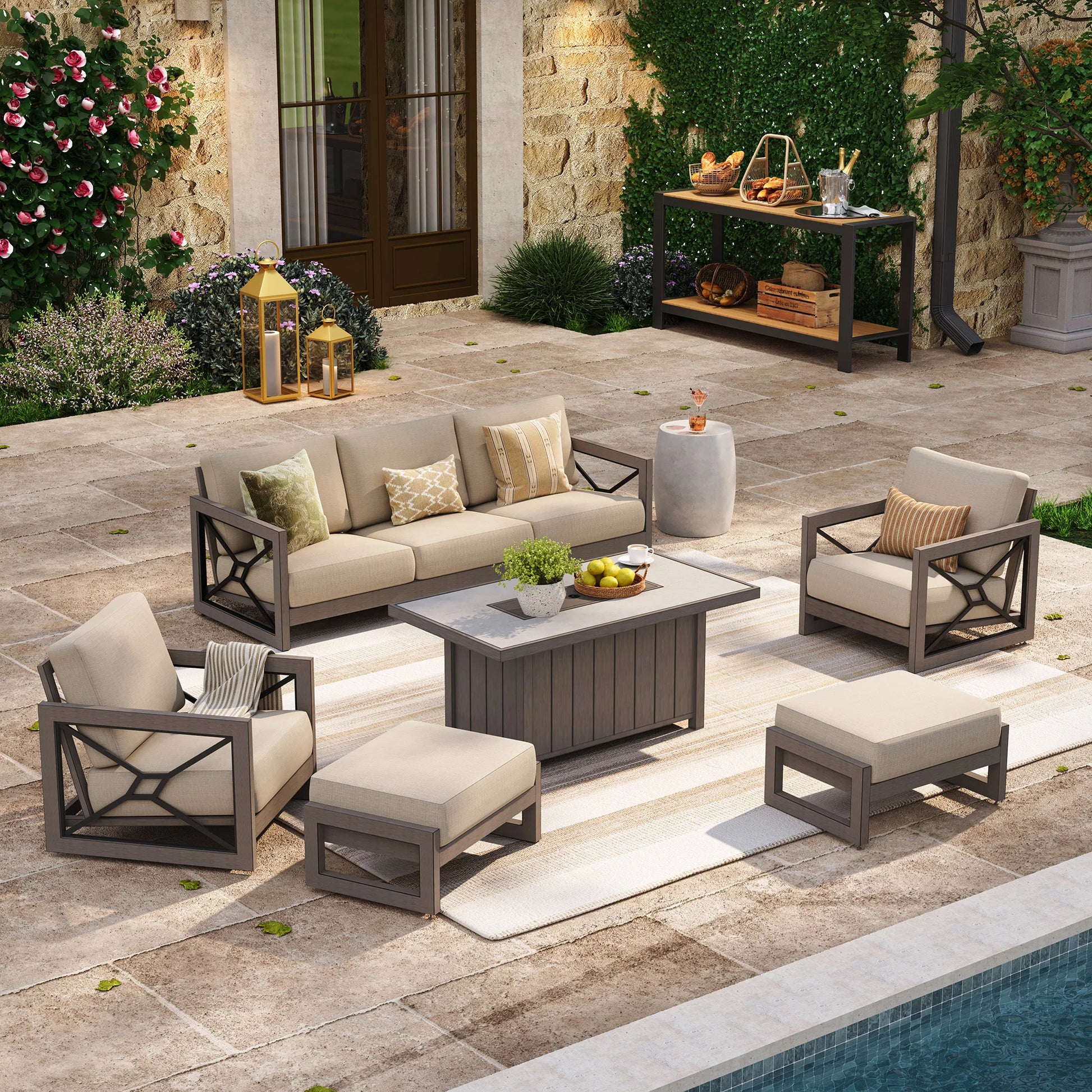 A poolside patio layout providing backyard gathering inspiration, showcasing the Marindo 6-piece wood-look aluminum seating set with club chairs, beige Sunbrella cushions, and a covered fire pit table.